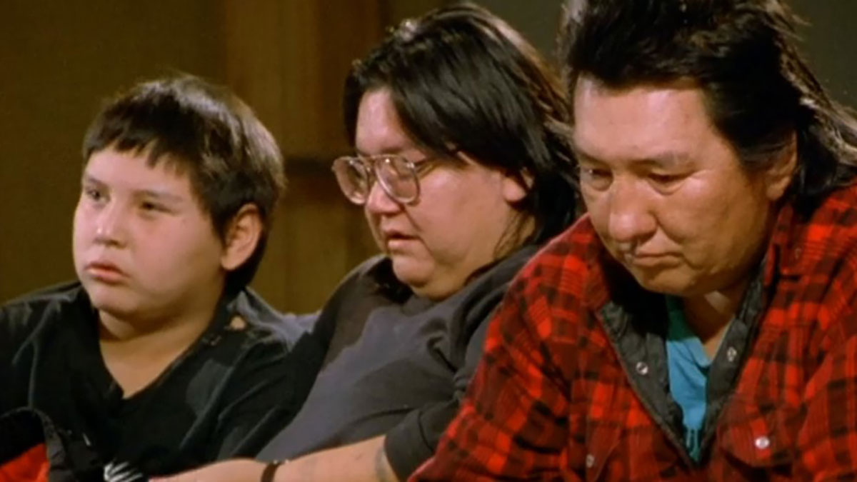 The males sitting together, looking offscreen