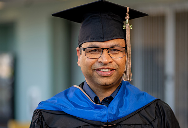 Graduate wearing glasses and smiling