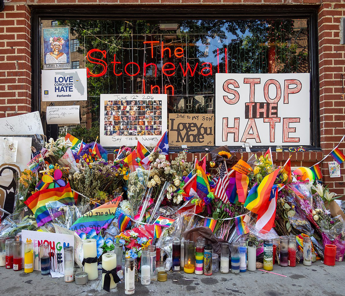 Stonewall Inn, a gay bar on Christopher Street in Manhattan's Greenwich Village, festooned with flowers and signs as part of Pride celebrations in 2018