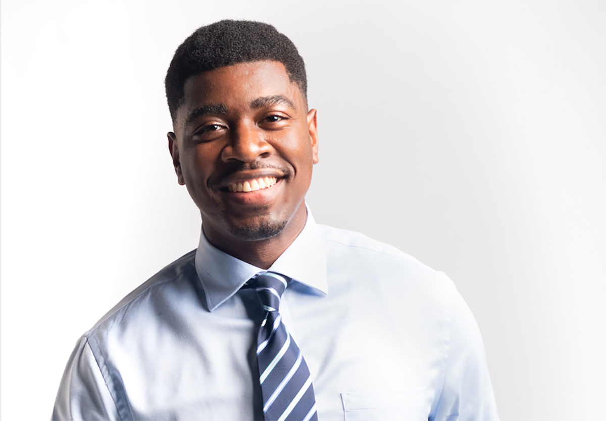 A smiling man in a shirt and tie