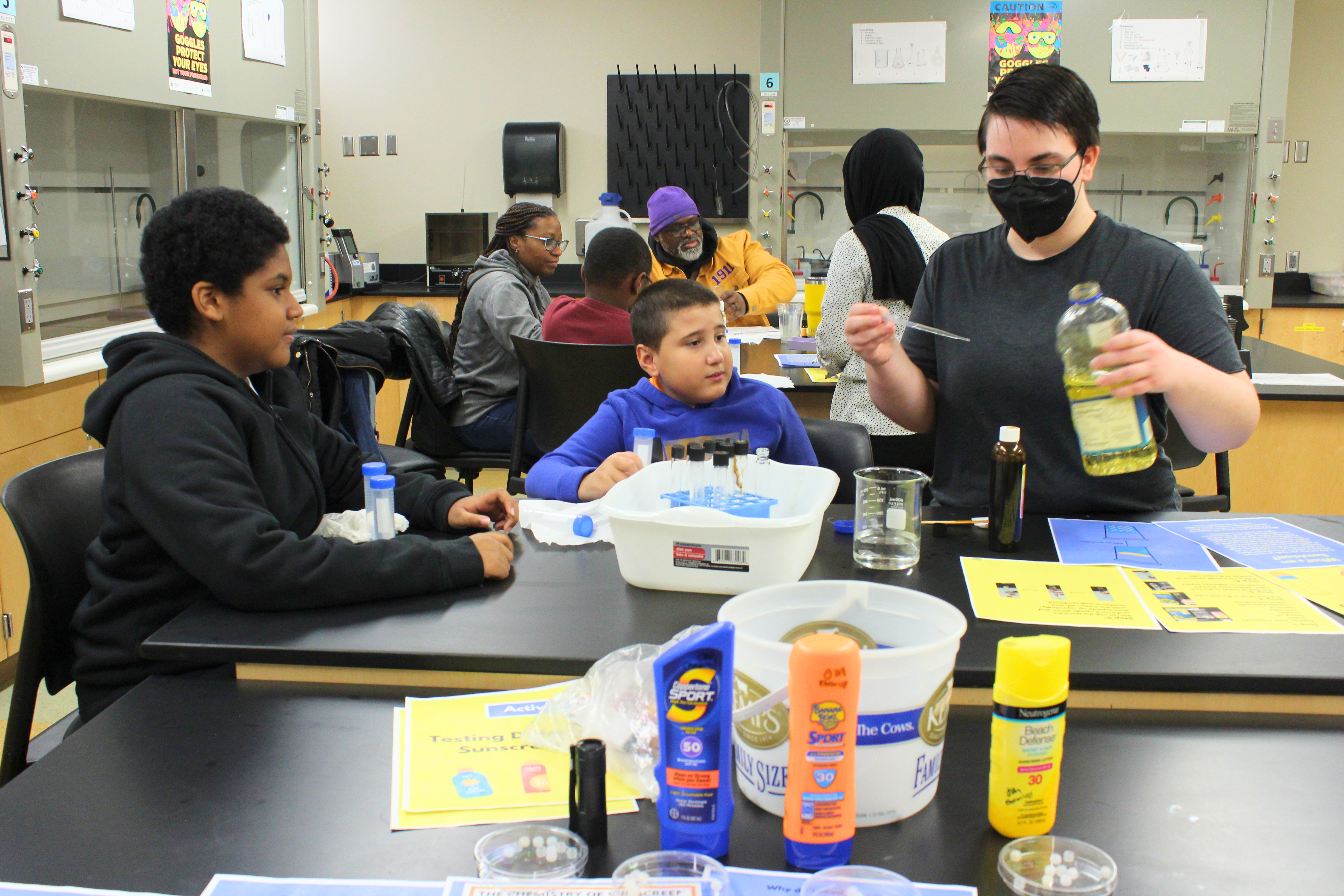 A group of children participating in a First Saturday Science activity