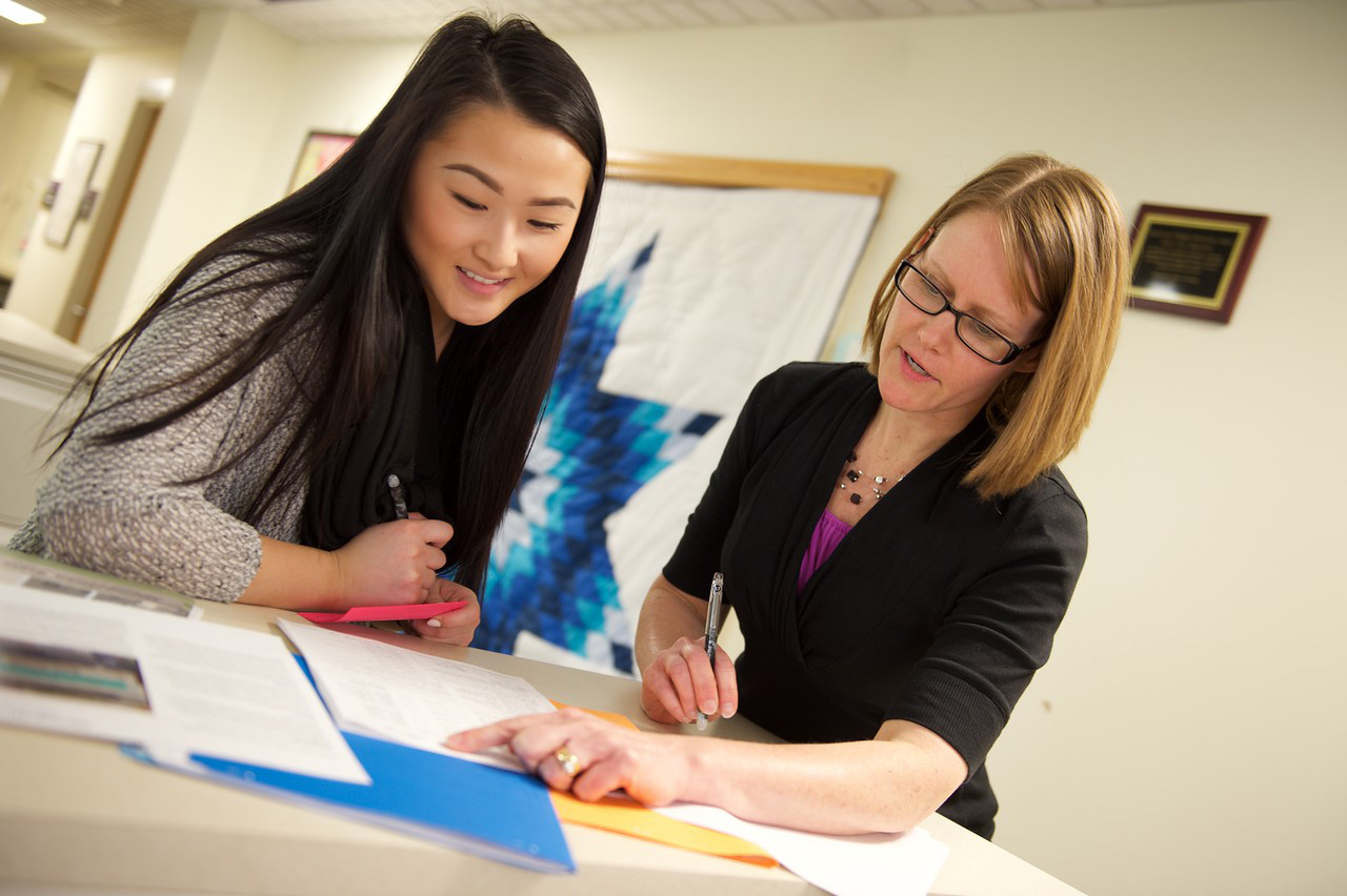 A student working with an advisor