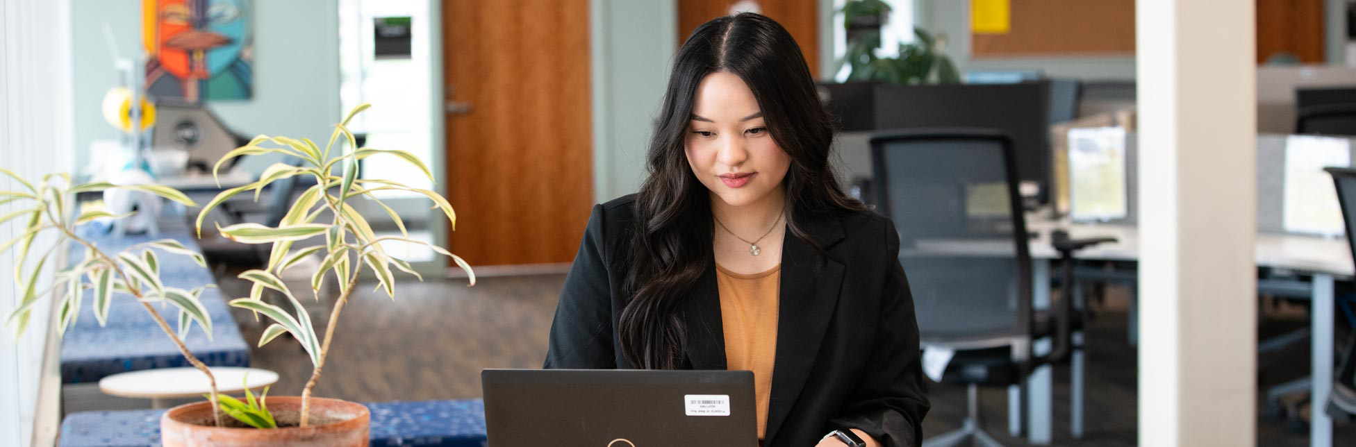 A person stis at a laptop