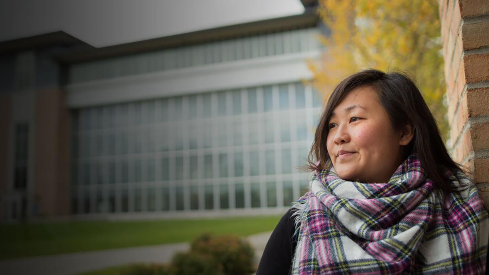 a woman in a scarf standing in front of New Main