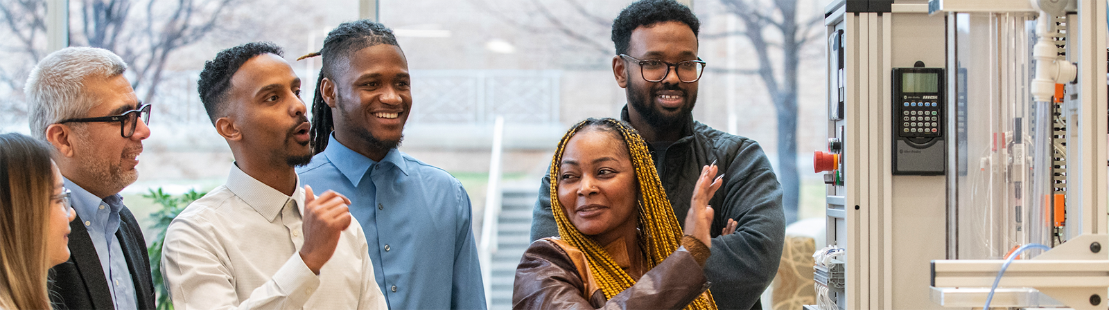 A group of people looking at a tech equipment suite