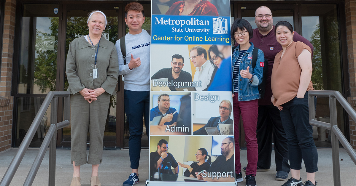 three nursing students from Singapore standing on the steps of Metro State's center for online learning with professor Eardley and Dominic Jennen