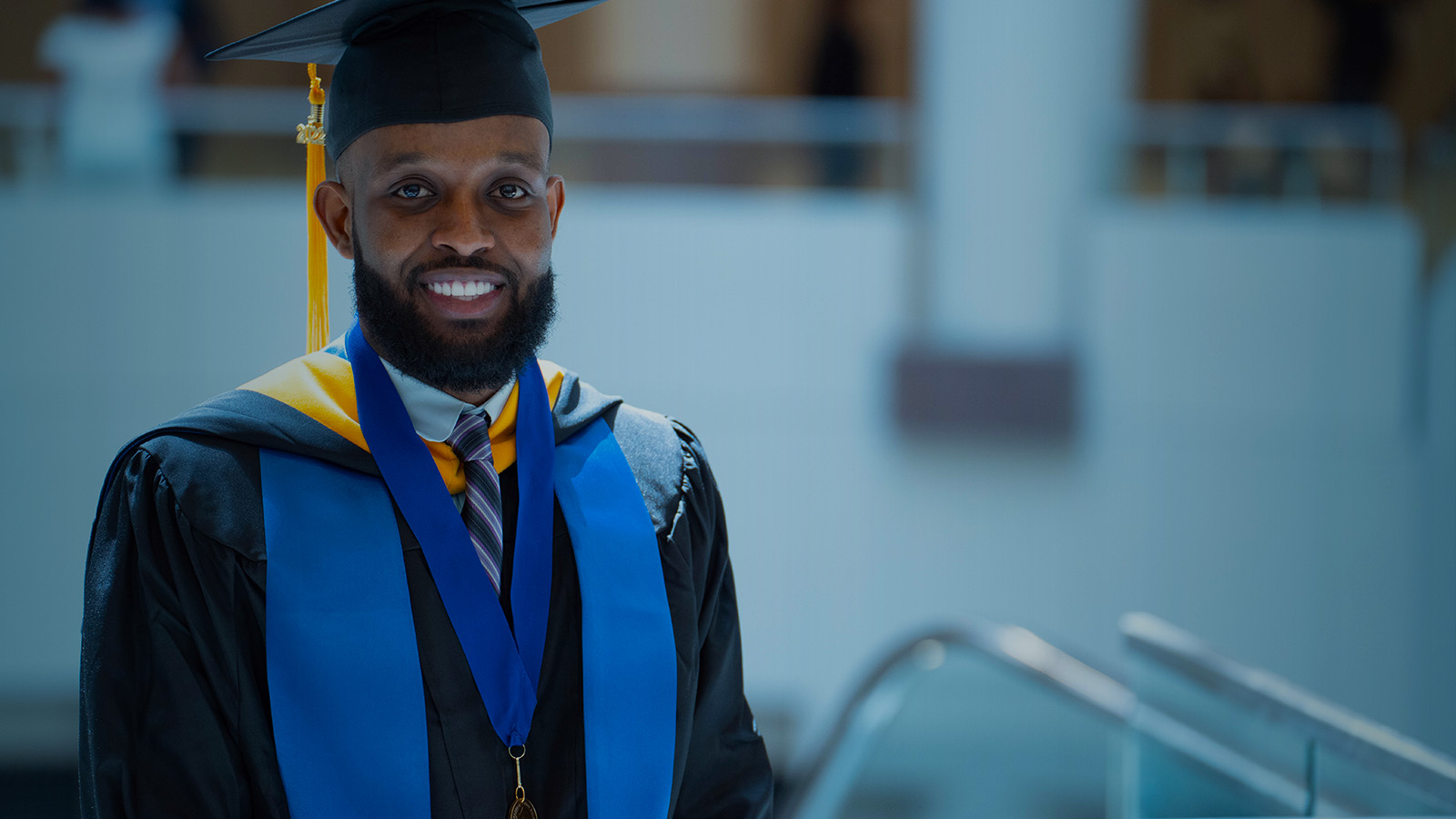 2022 graduate smiling and looking at camera