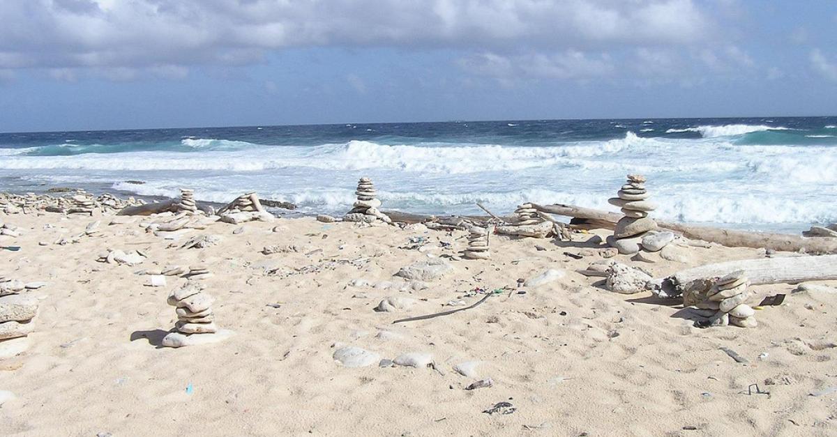 Beach, sand, ocean, clouds, stacked rock cairns