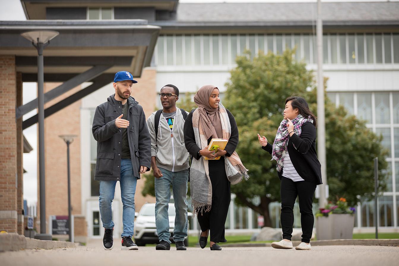 A group of students walks on the Saint Paul Campus