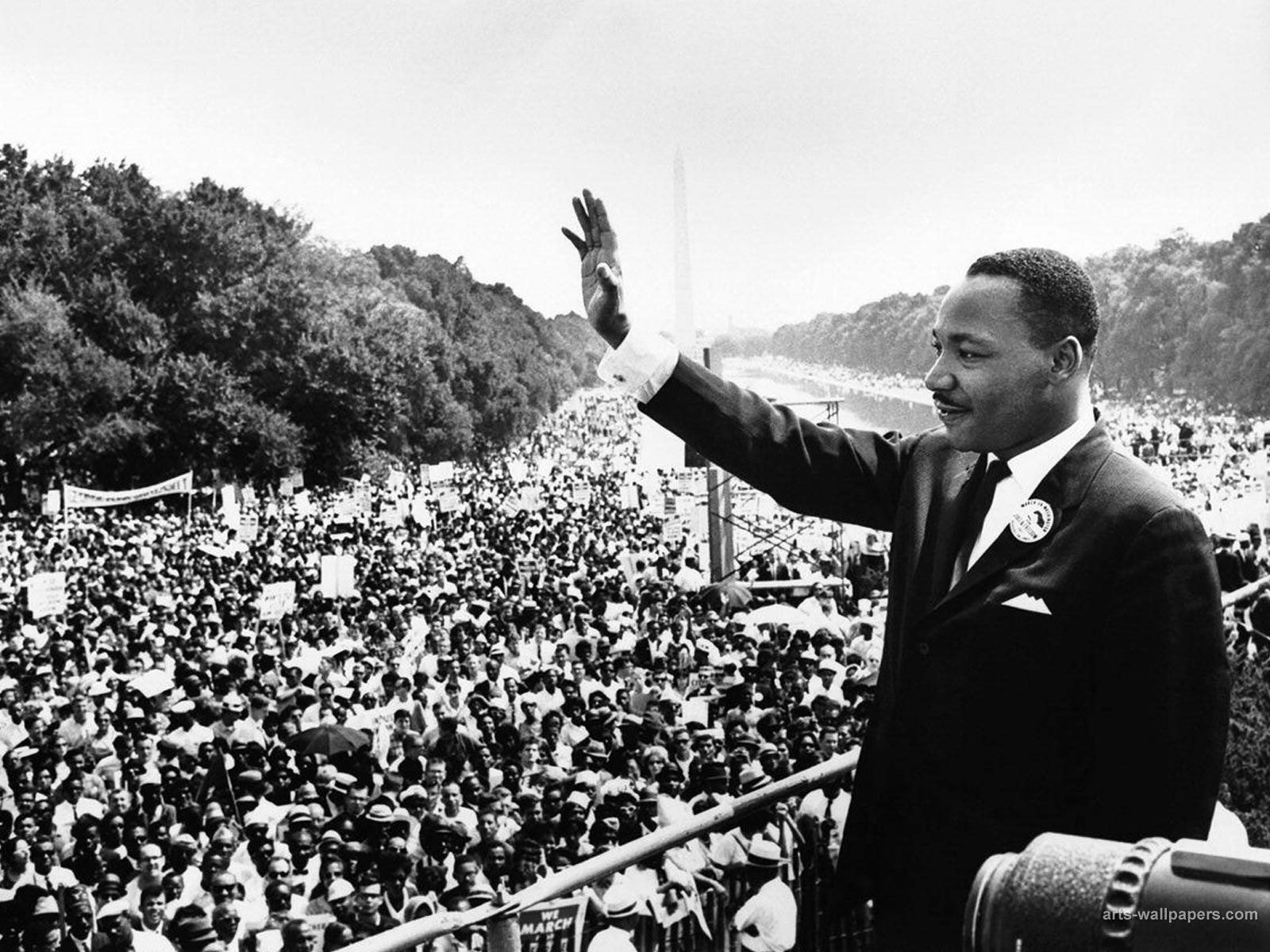 Martin Luther King Jr. waving to a crowd gathered in Washington D.C. on the National Mall