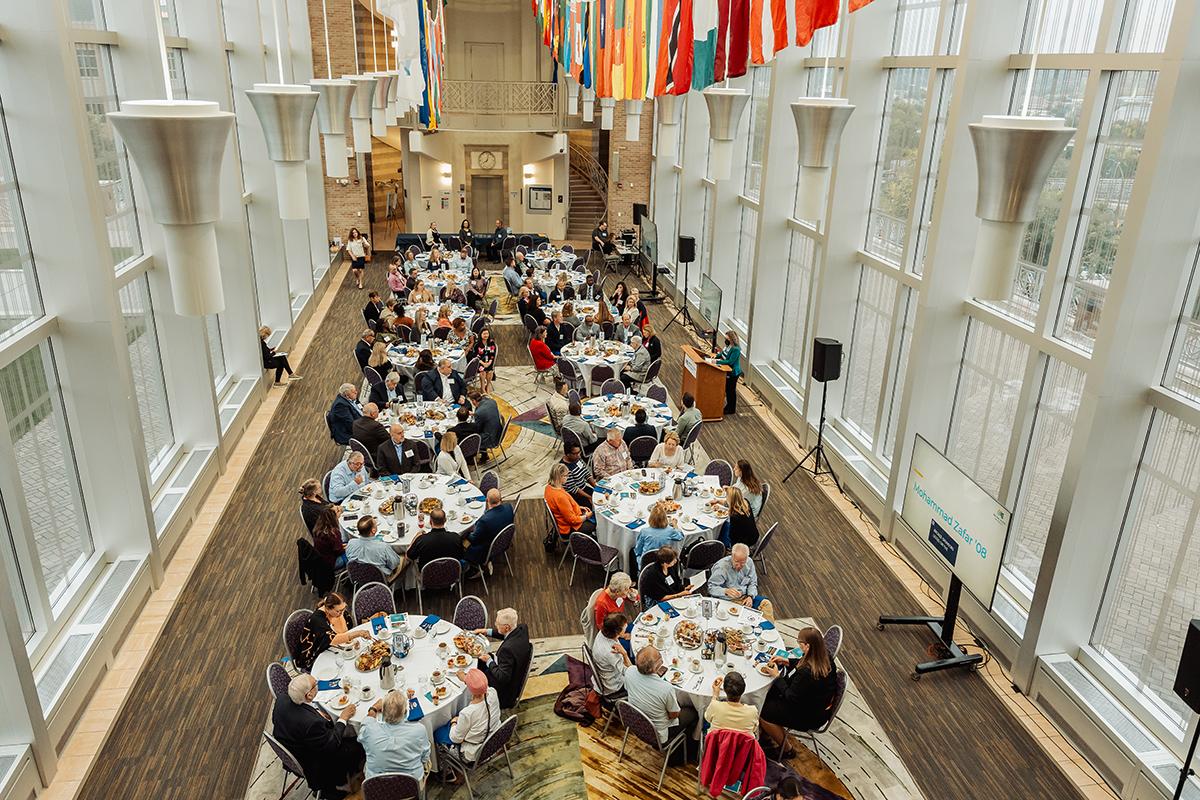 Tables of people at the Rise to Shine Breakfast in the Great Hall as seen from above