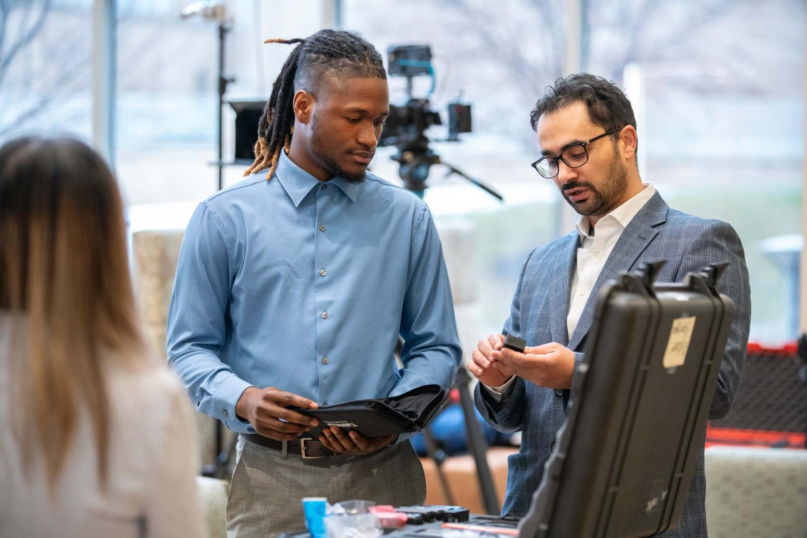 an instructor explains a piece of equipment to a student
