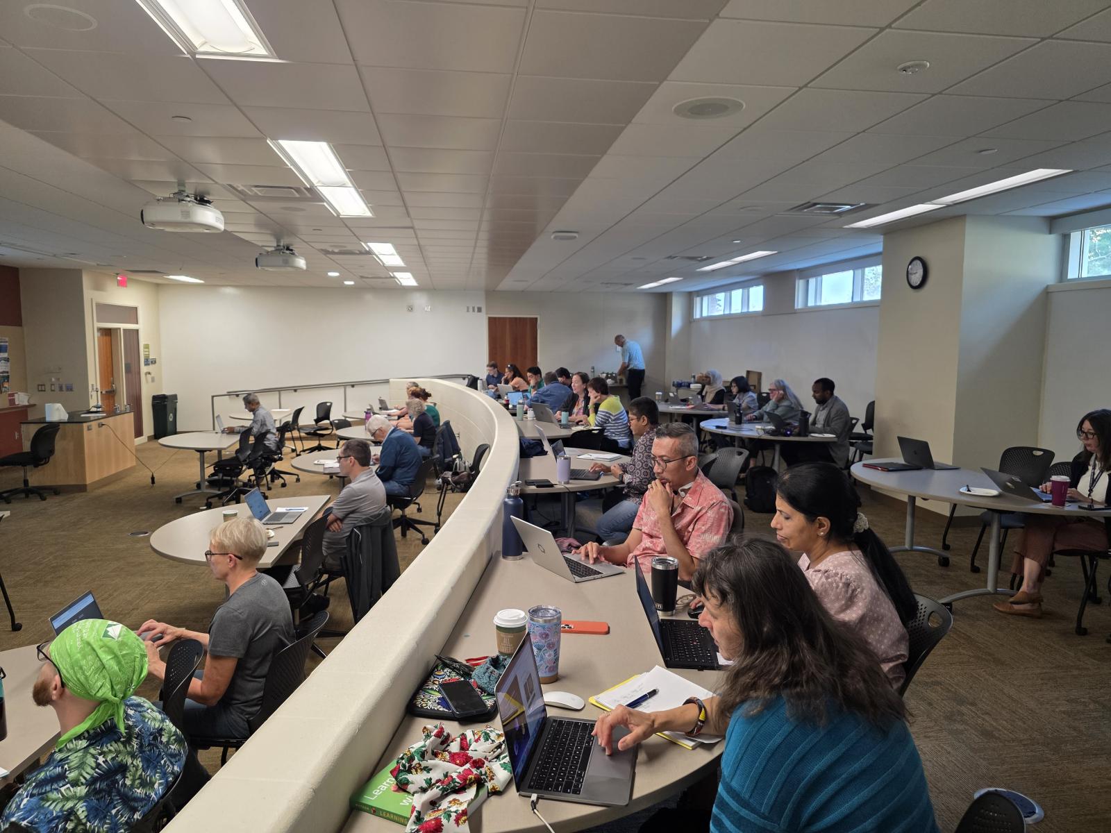 Participants at the Interdisciplinary AI Workshop for Educators work on exercises in a classroom