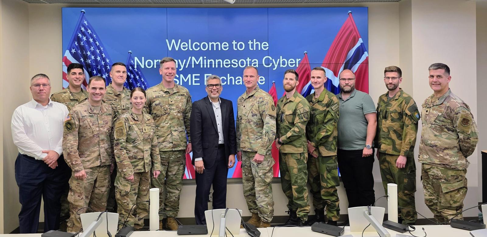 a group of participants in a cybersecurity information exchange pose for a picture