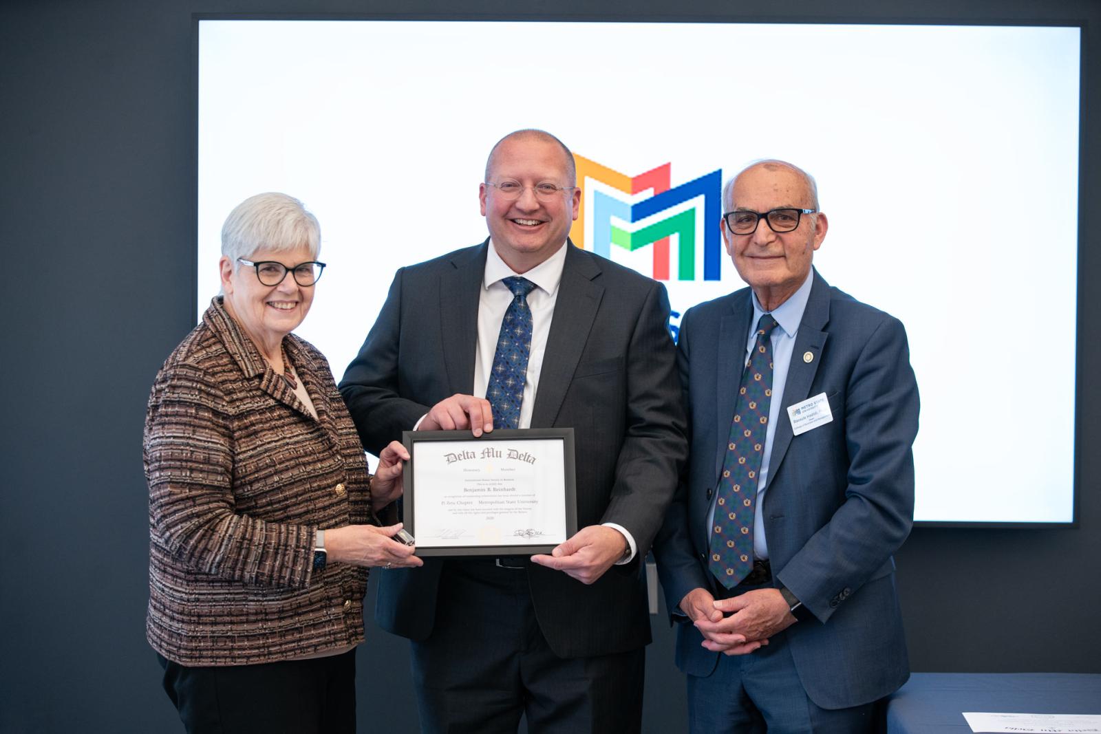 Three people pose for a picture: President Virginia (Ginny) Arthur, Honorary Inductee Benjamin B. Reinhardt, and Dean Hadidi, March 28, 2026