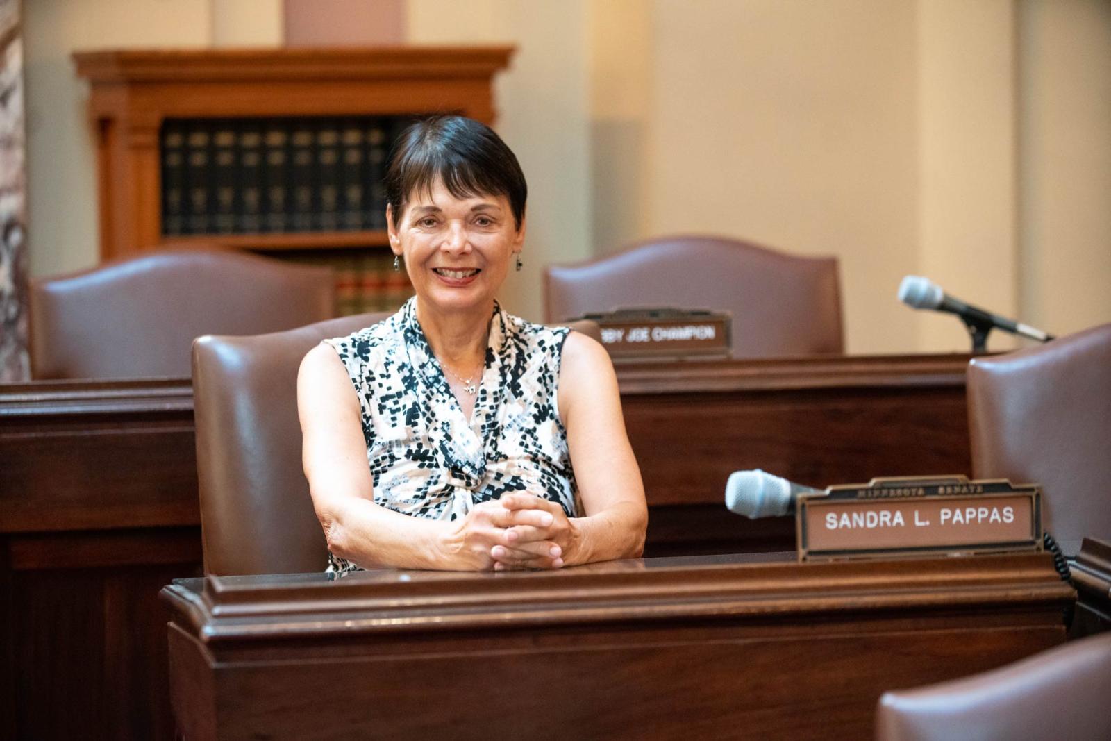 Senator Sandy Pappas sitting at her seat in the Minnesota State Senate chambers