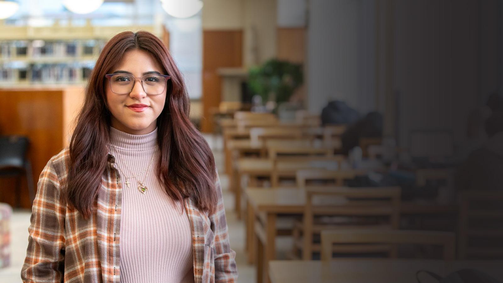 Student stands in the library