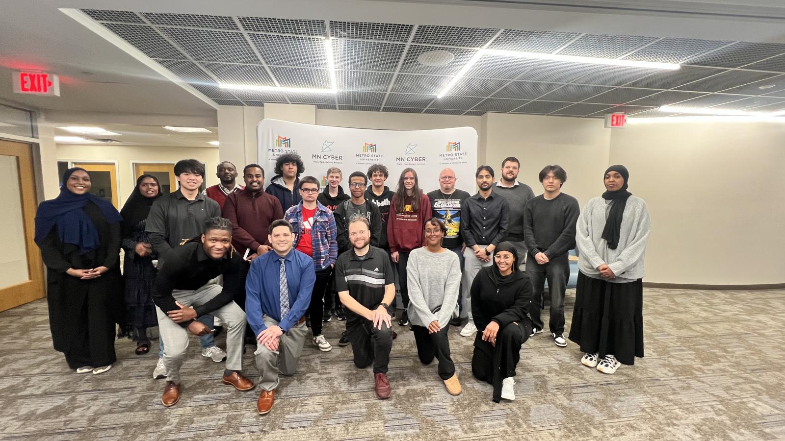 A group of people posing for a photo in a computer labup o