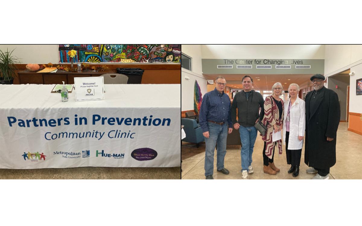 A table with Partners in Prevention Community Clinic tablecloth next to a picture of five people standing for a picture 