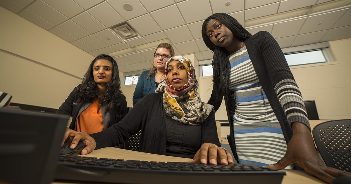 A group of women working together at a computer