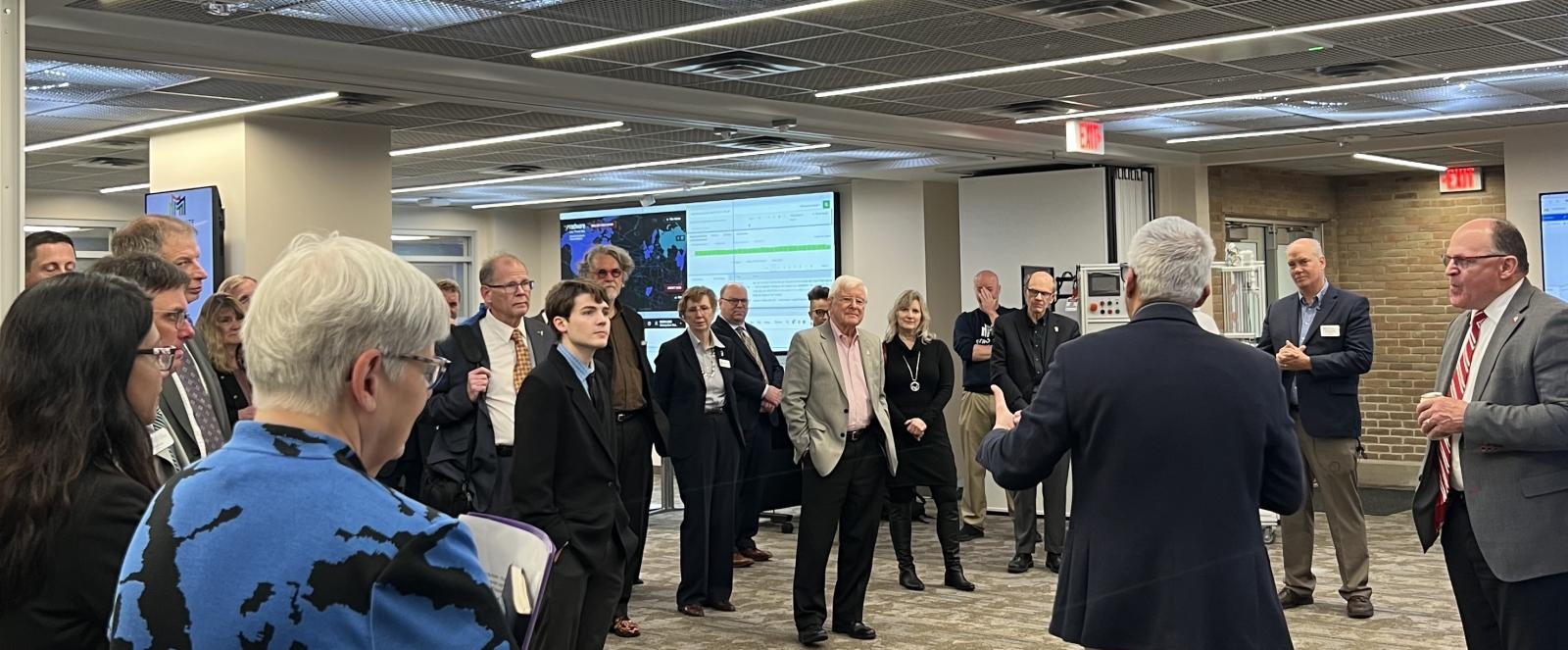 A group of people gather in Metro State's educational Security Operations Center