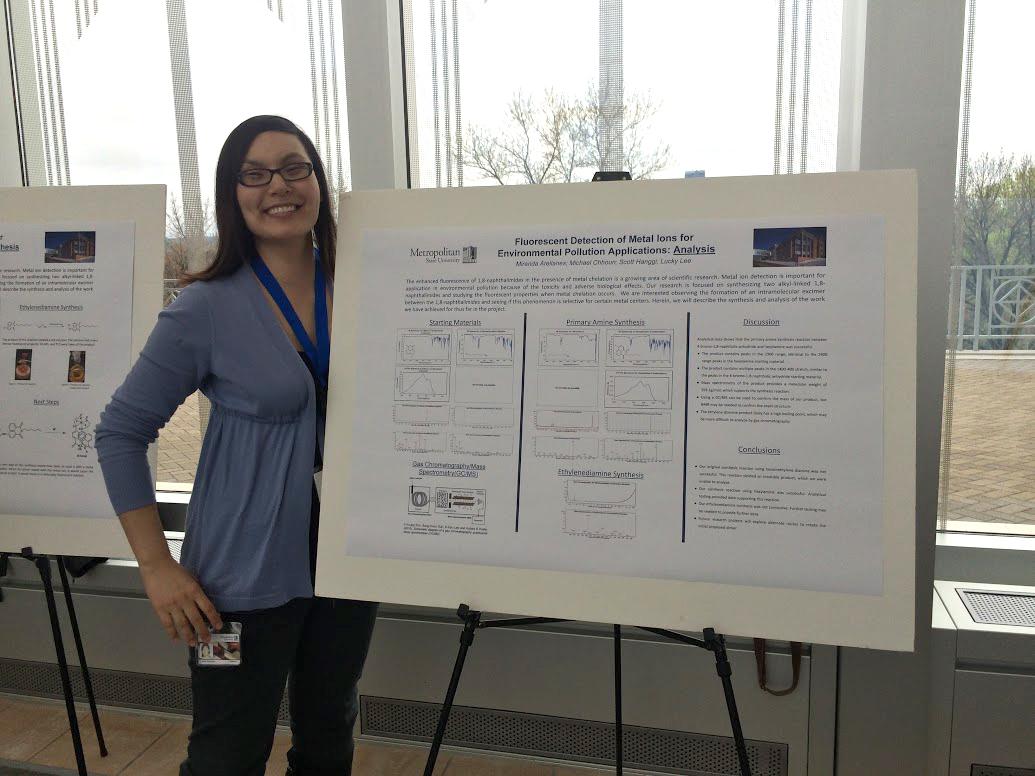 Woman displays her work at the Student Poster Conference