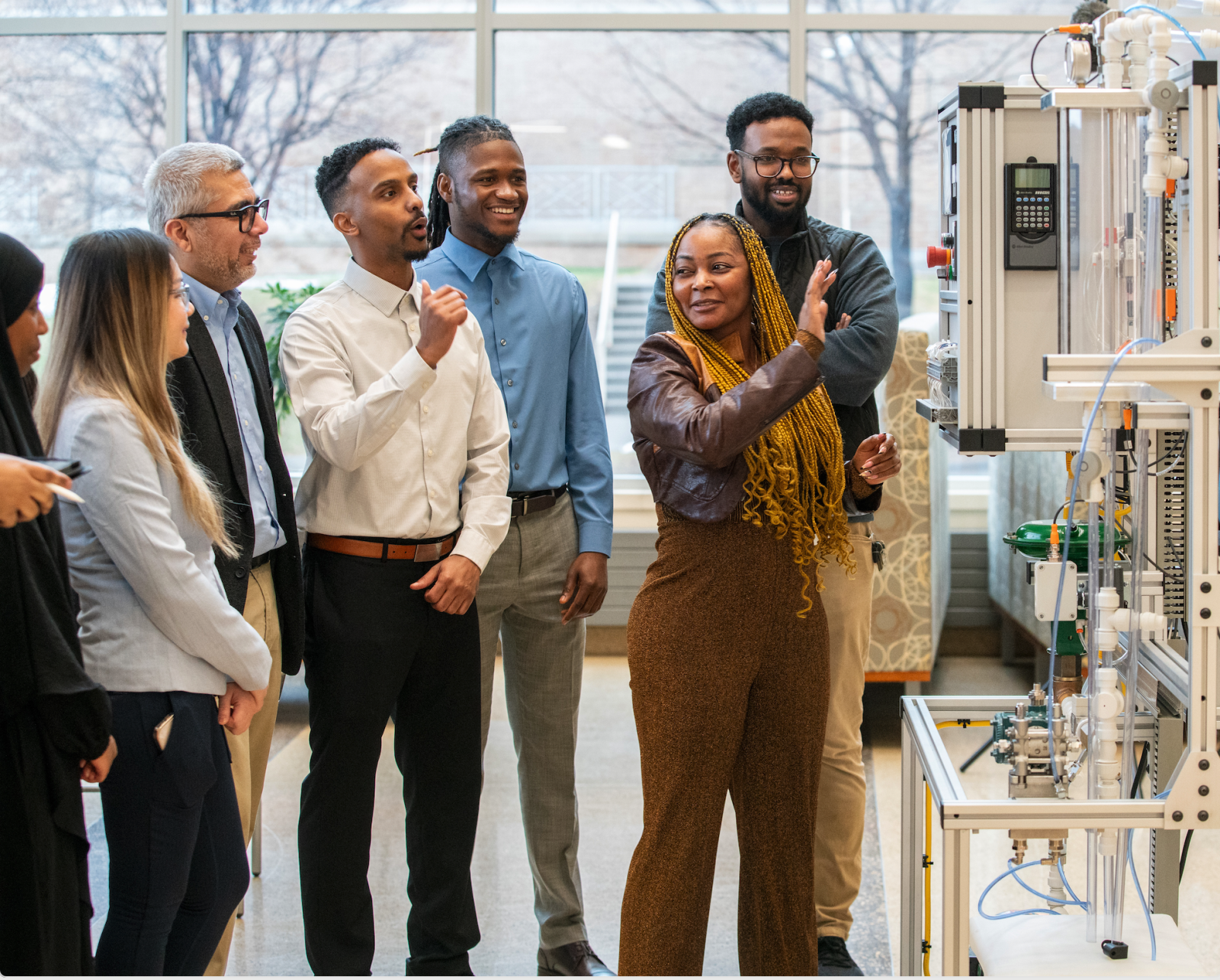 A group of people in a lab setting having a discussion