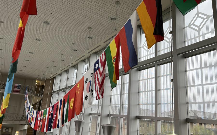 An image of national flags flying from two lines in New Main Great Hall