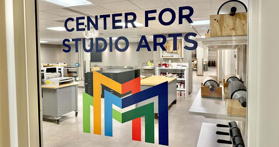Center for Studio Arts and the Metro State icon on a glass door looking into art spaces within