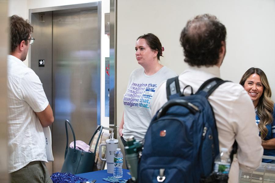 A group of people talking at a job fair table