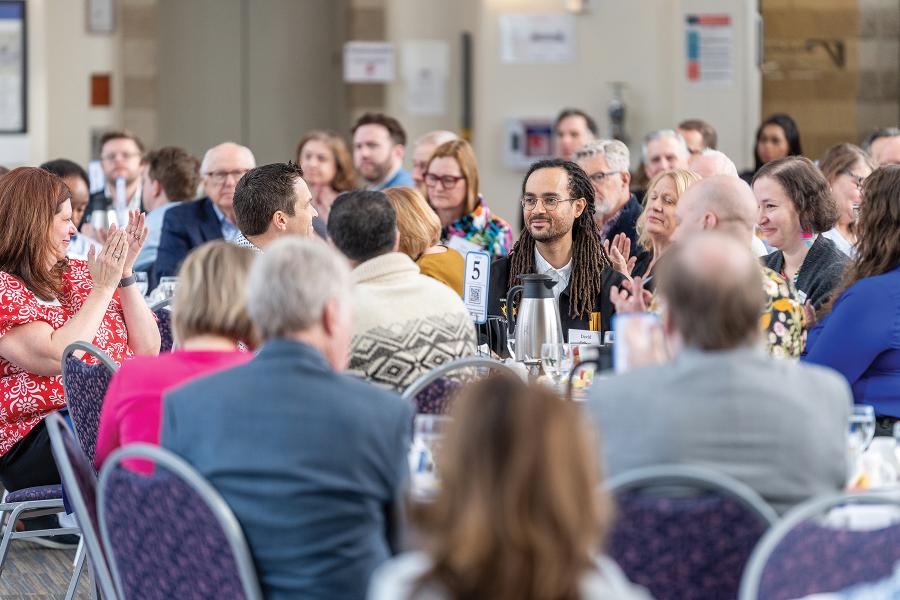 A group of people gathered in New Main Great Hall at tables