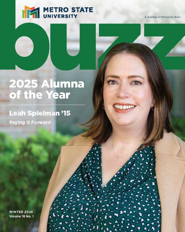 Leah Spielman, 2025 Alumna of the Year, poses in a green speckled top and tan jacket on the cover of the Spring 2026 buzz magazine 