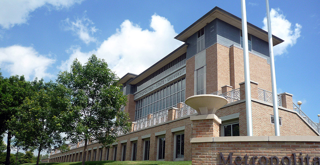 Exterior of Metro State University’s New Main building on the Saint Paul campus, surrounded by trees and brick campus architecture.